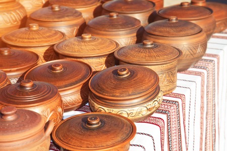 There are many clay pots on the tableの写真素材
