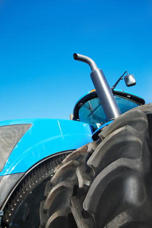 Tire on blue tractor close up in the foregroundの写真素材