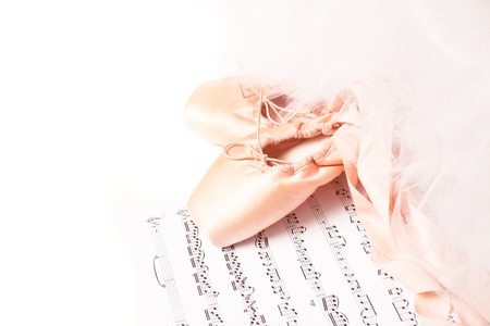 Ballet shoes, skirt and music sheet on a white backgroundの写真素材