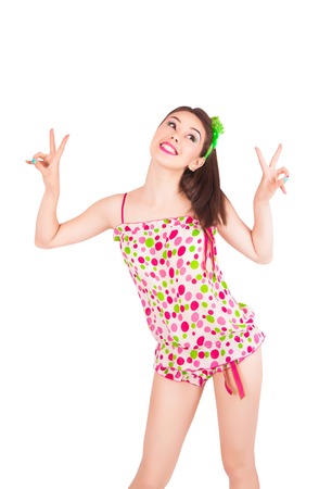Portrait of pretty young brunette woman in colorful pajamas in the studio, isolated on a white backgroundの写真素材