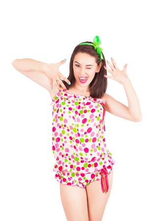 Portrait of pretty young brunette woman in colorful pajamas in the studio, isolated on a white backgroundの写真素材