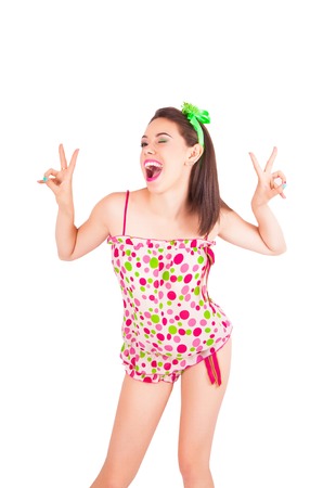 Portrait of pretty young brunette woman in colorful pajamas in the studio, isolated on a white backgroundの写真素材