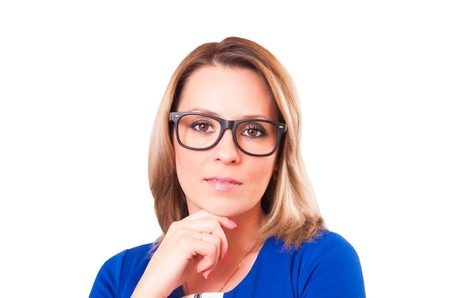 Portrait of pensive woman in glasses close-up isolated on white backgroundの写真素材