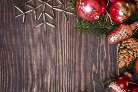 Vintage Christmas ornaments, tree branches and other decorations on the wooden background. New Year background. The concept of the winter holidays.の写真素材