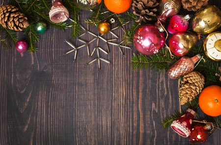 Vintage Christmas ornaments, tree branches and other decorations on the wooden background. New Year background. The concept of the winter holidays.の写真素材