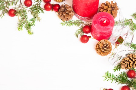 Red candles fir branches and Christmas decorations on a white backgroundの写真素材