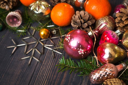 Vintage Christmas ornaments, tree branches and other decorations on the wooden background. New Year background. The concept of the winter holidays.の写真素材