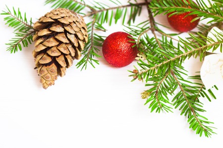 Red Christmas balls, fir branches and cones on a white backgroundの写真素材