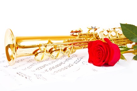 Musical notes and saxophone with red flowerの写真素材