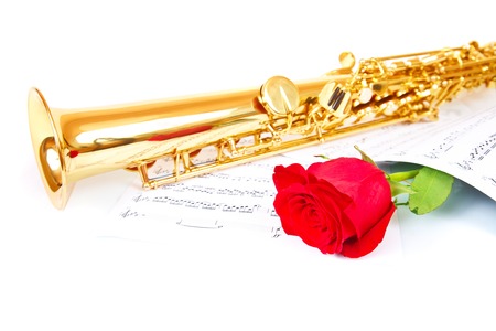 Musical notes and saxophone with red roseの写真素材