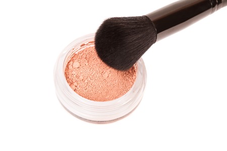 Powder blush and black makeup brush on white backgroundの写真素材