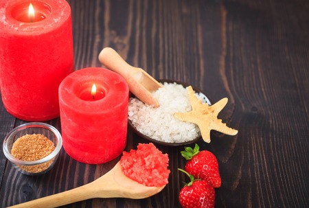 Strawberry body scrub with brown sugar and sea salt on the wooden backgroundの写真素材