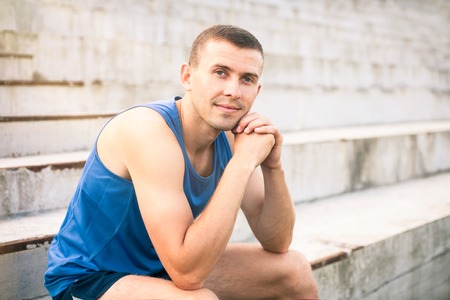 Portrait of a young man in a blue shirt closeup.の写真素材