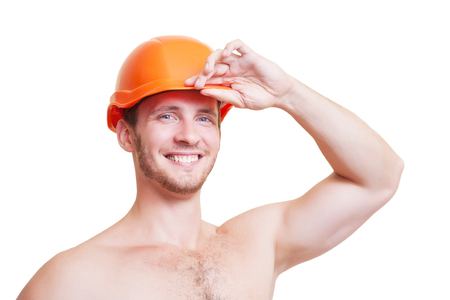 Attractive young man in an orange construction helmet, isolated on white background.の写真素材