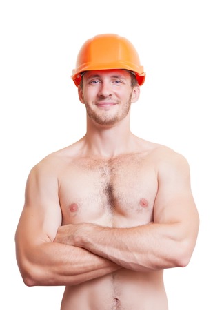 Attractive young man in an orange construction helmet, isolated on white background.の写真素材