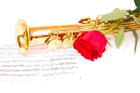 Musical notes and saxophone with red roseの写真素材