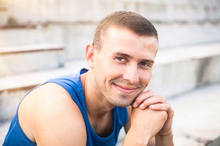 Portrait of a young man in a blue shirt closeup.の写真素材