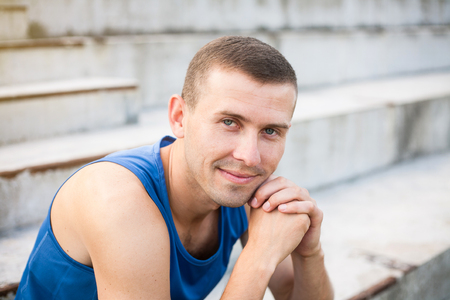 Portrait of a young man in a blue shirt closeup.の写真素材