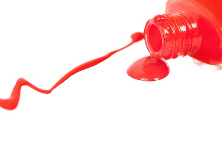 Red nail polish spilled. Isolated on a white background.の写真素材