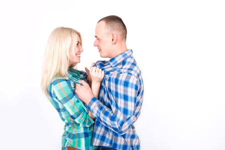 Man and woman playfully quarrel in the studio on a white background.の写真素材