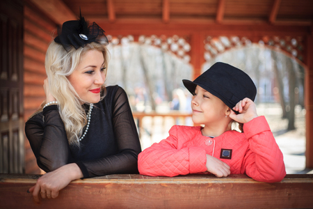 Happy mother and daughter portrait in retro style outdoors on a sunny day.の写真素材