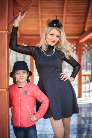 Happy mother and daughter portrait in retro style outdoors on a sunny day.の写真素材