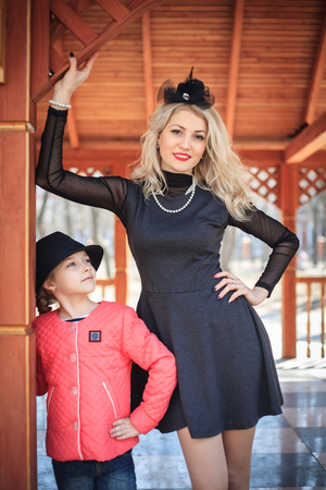 Happy mother and daughter portrait in retro style outdoors on a sunny day.の写真素材