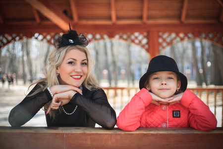 Happy mother and daughter portrait in retro style outdoors on a sunny day.の写真素材