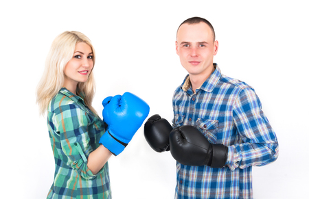 Studio shot of a beautiful funny couple expressive fighting on a white background.の写真素材