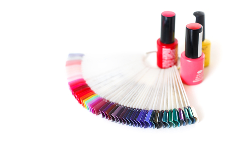 Samples of colored nail polish on a white table. Nail salon.の写真素材