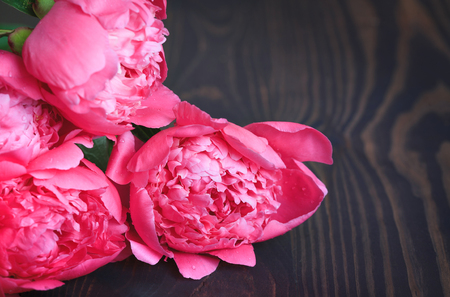 Pink peonies on a wooden table. Beautiful floral background.の写真素材