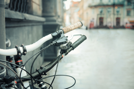 Bicycle close-up on a city street. Copy space. Beautiful vintage urban background.の写真素材