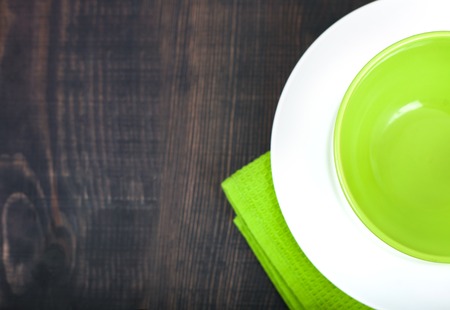 Empty plate and towel over wooden table background. Top view with copy spaceの写真素材