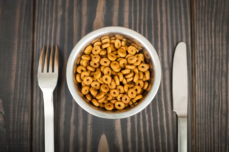 Cat food and cutlery on a wooden table. The concept of pet food.の写真素材