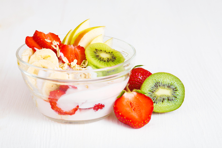 Yogurt with exotic fruits on a white background in the studio. The concept of a healthy diet.の写真素材