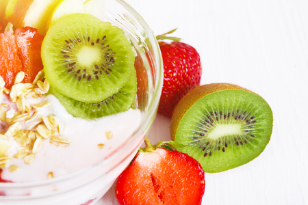 Yogurt with exotic fruits on a white background in the studio. The concept of a healthy diet.の写真素材