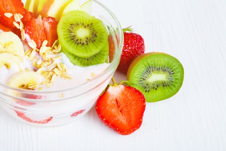 Yogurt with exotic fruits on a white background in the studio. The concept of a healthy diet.の写真素材
