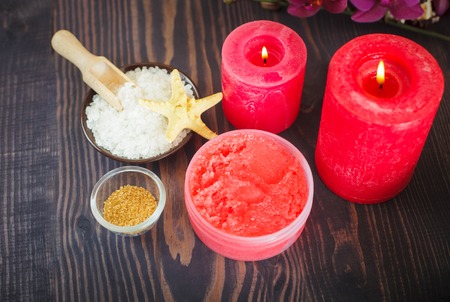 Candles and set of items for body care on a wooden background. The concept of relaxation and spa procedures.の写真素材