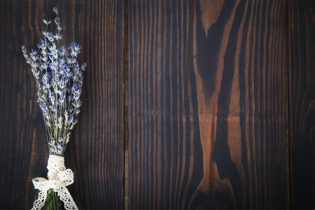A bunch of lavender on a wooden table. Background in vintage styleの写真素材