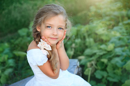 Cute little girl on nature in bright summer dayの写真素材