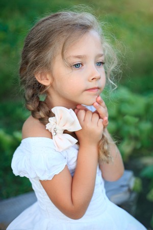 Cute little girl on nature in bright summer dayの写真素材
