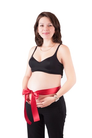 Beautiful pregnant woman with red ribbon isolated on white backgroundの写真素材