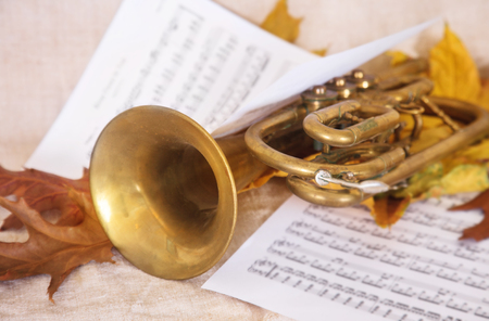 Musical notes, autumn leaves and old trumpet.の写真素材