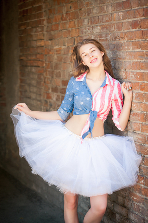 Portrait of teen girl in a bright clothes outdoorsの写真素材
