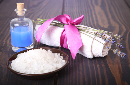 Lavender, salt on a wooden board, hygiene items for bath and spa.の写真素材
