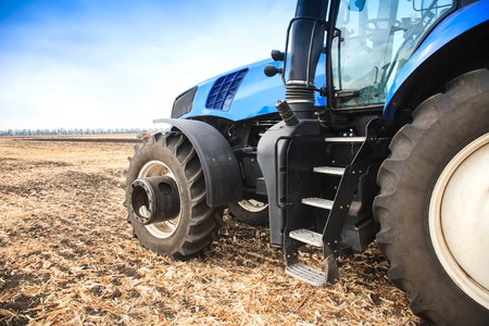 A wheel from a tractor working in the field close up. The concept of field work and agriculture.の写真素材
