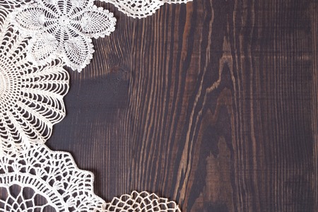 Vintage knitted lace on the background of wooden boards. Background in retro style.の写真素材