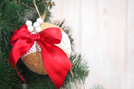 Christmas or New Year rustic wooden background with toy decorations and fur tree branch, copy space.の写真素材