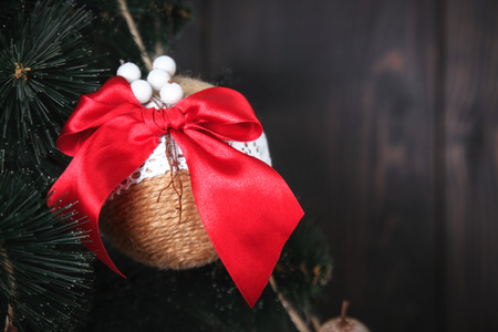 Christmas or New Year rustic wooden background with toy decorations and fur tree branch, copy space.の写真素材