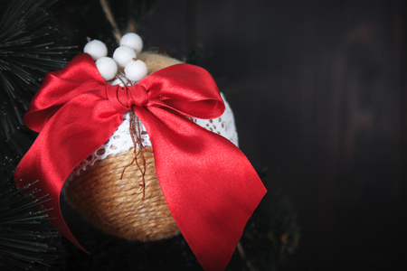 Christmas or New Year rustic wooden background with toy decorations and fur tree branch, copy space.の写真素材